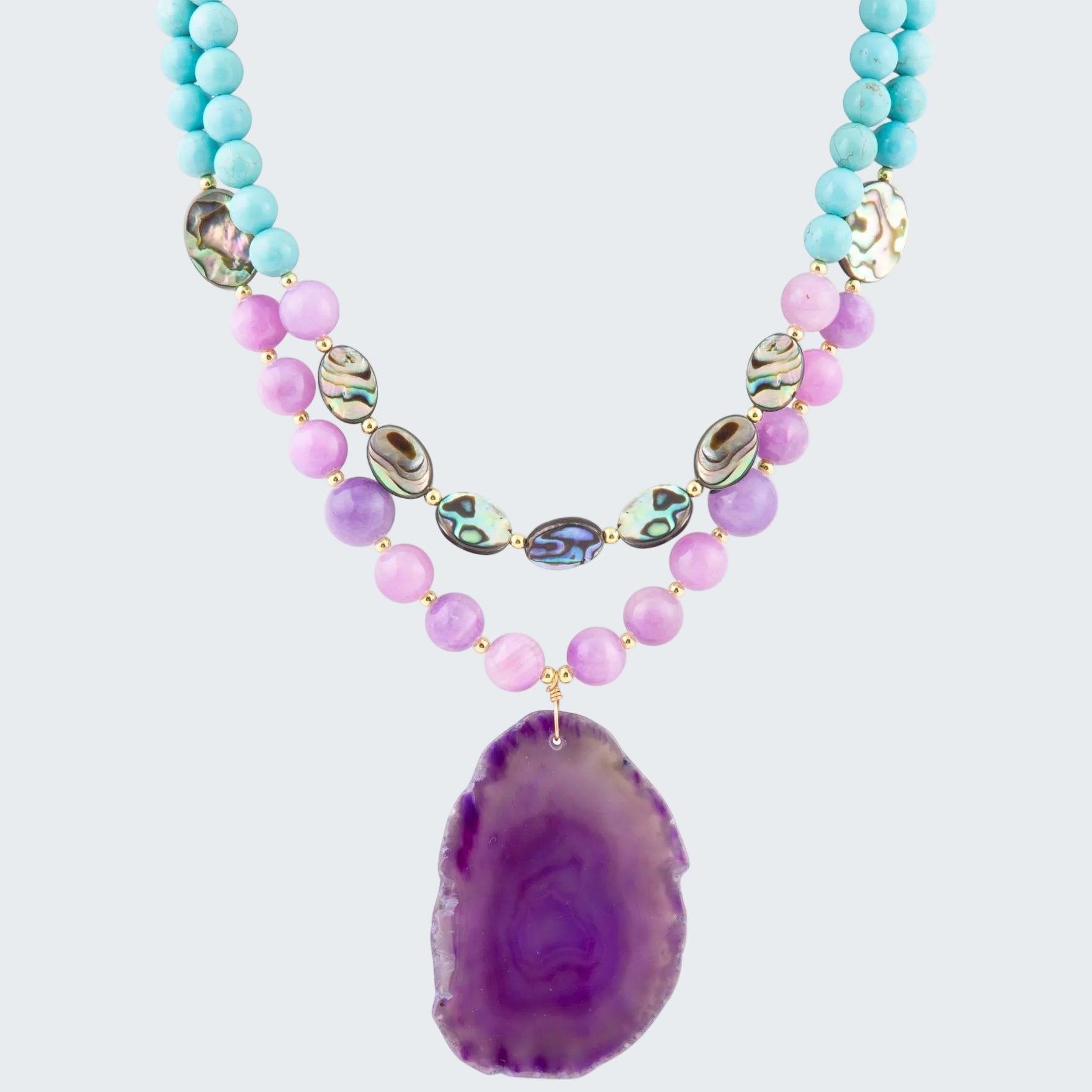Necklace with purple agate pendant and multicolored beads on a white background
