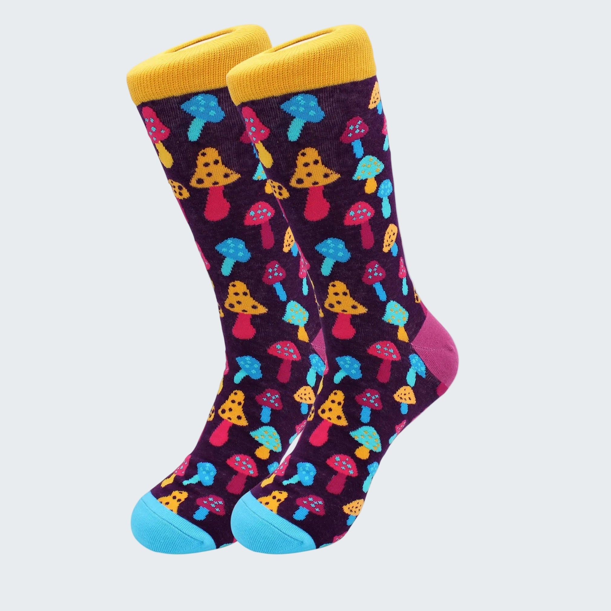 Colorful mushroom-patterned socks with yellow cuffs and blue toes on a white background