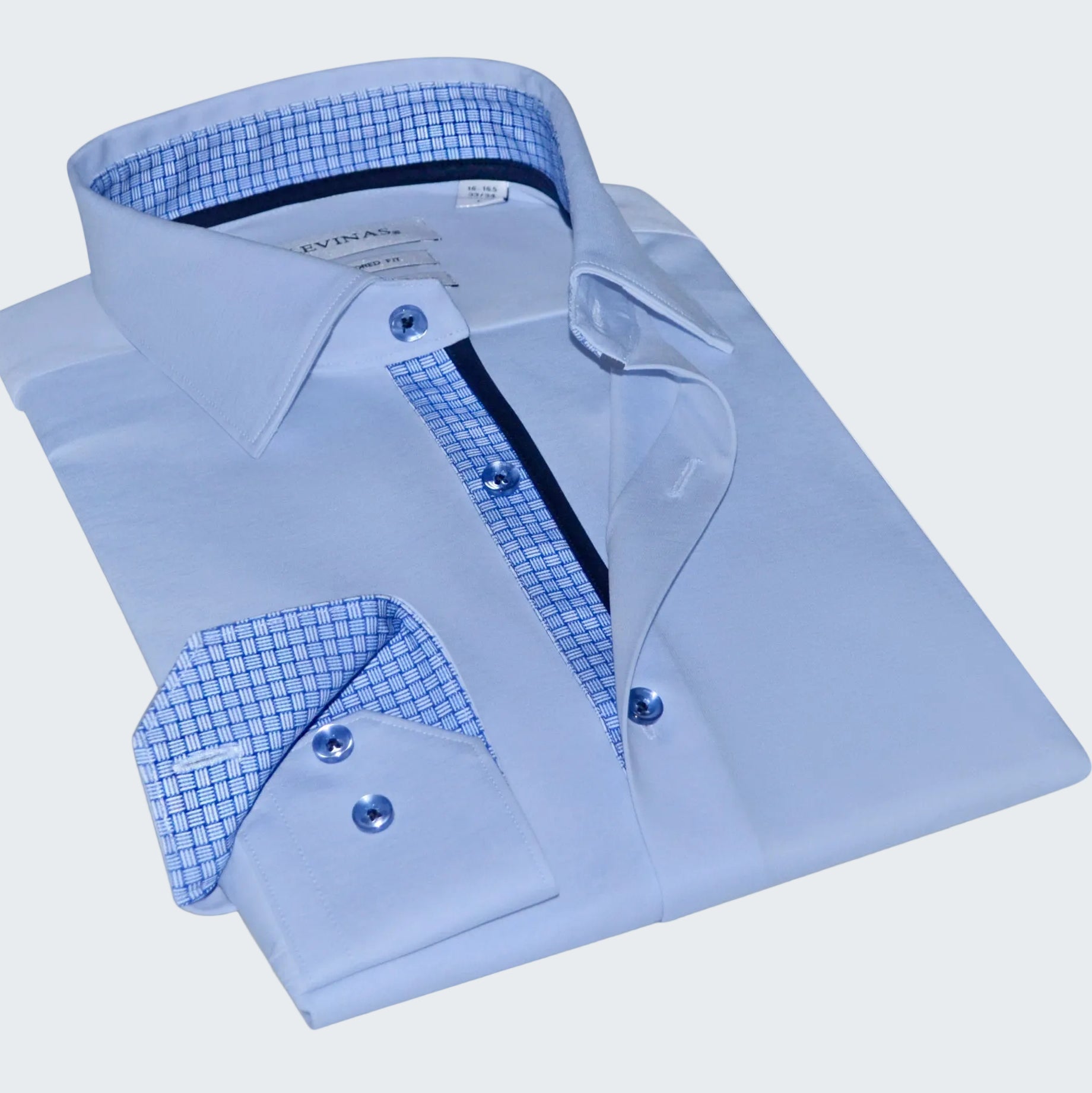 Folded light blue dress shirt with checkered interior on a white background