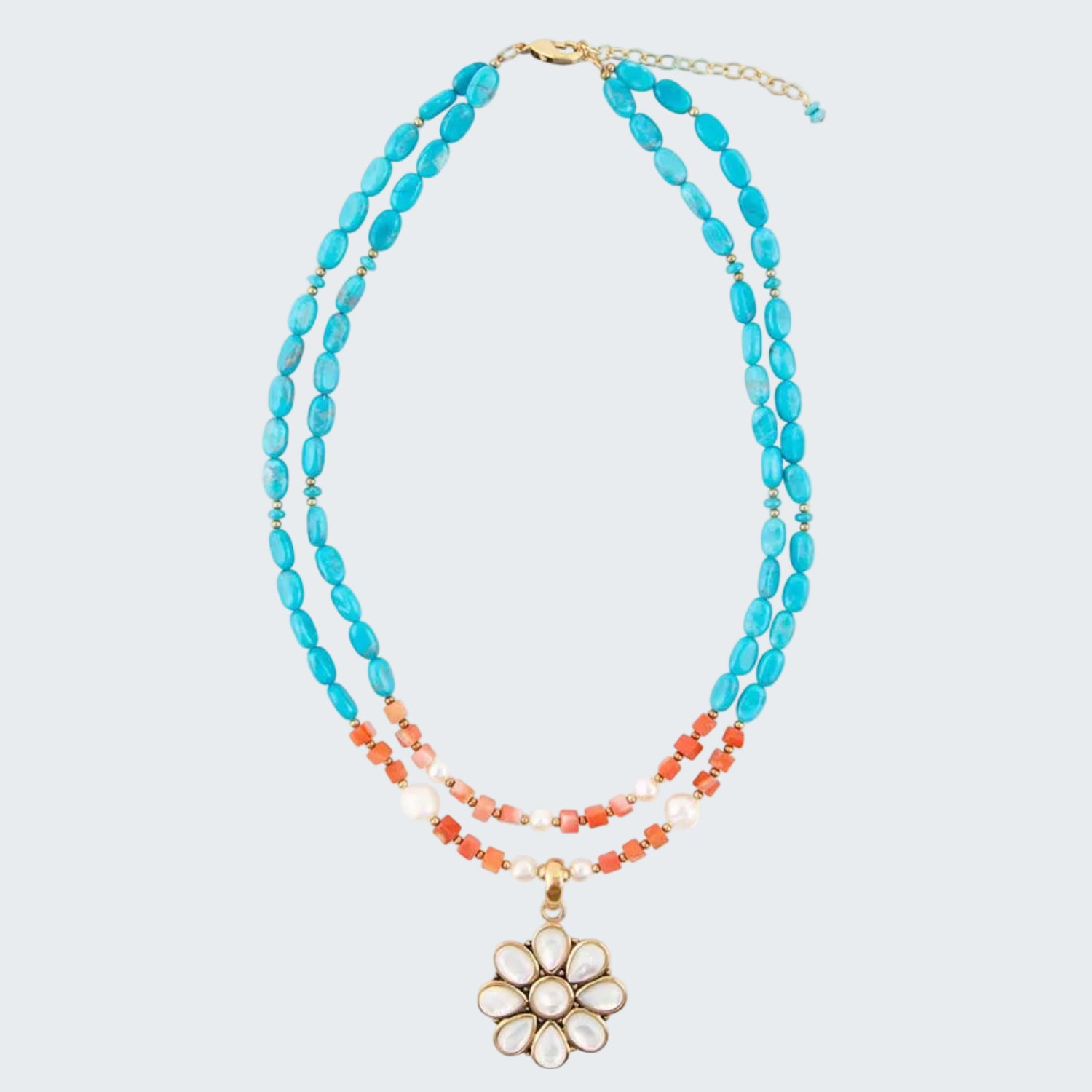 Multistrand necklace with turquoise, coral, and white beads and a floral pendant on a white background