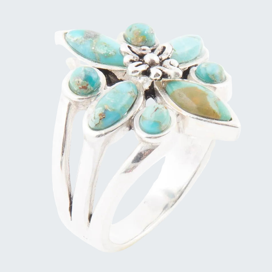 Silver ring with turquoise stones on a white background