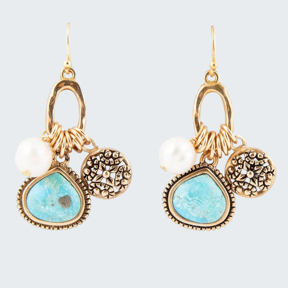 Pair of gold and turquoise earrings with pearls on a white background