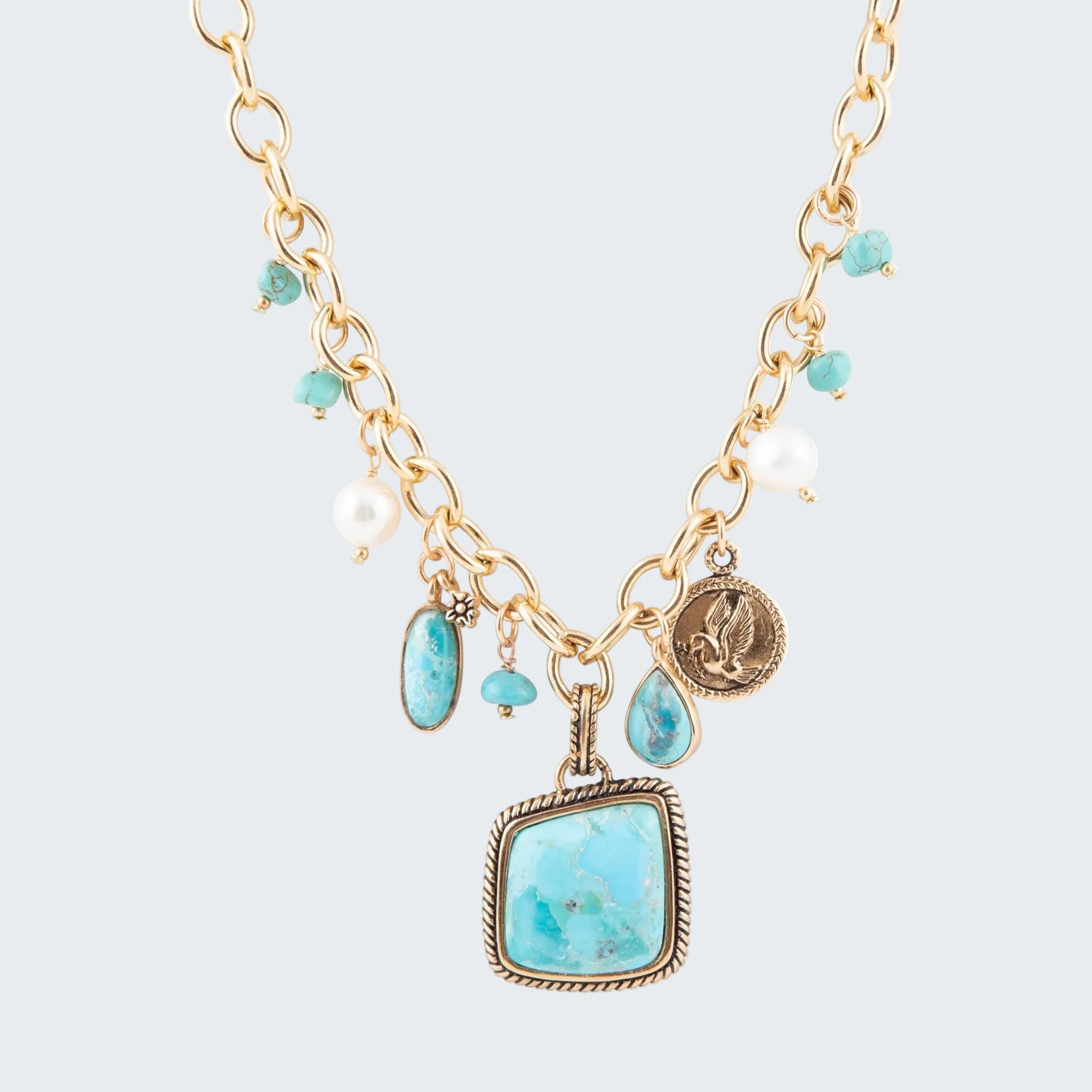 Necklace with turquoise stones and gold chain on a white background