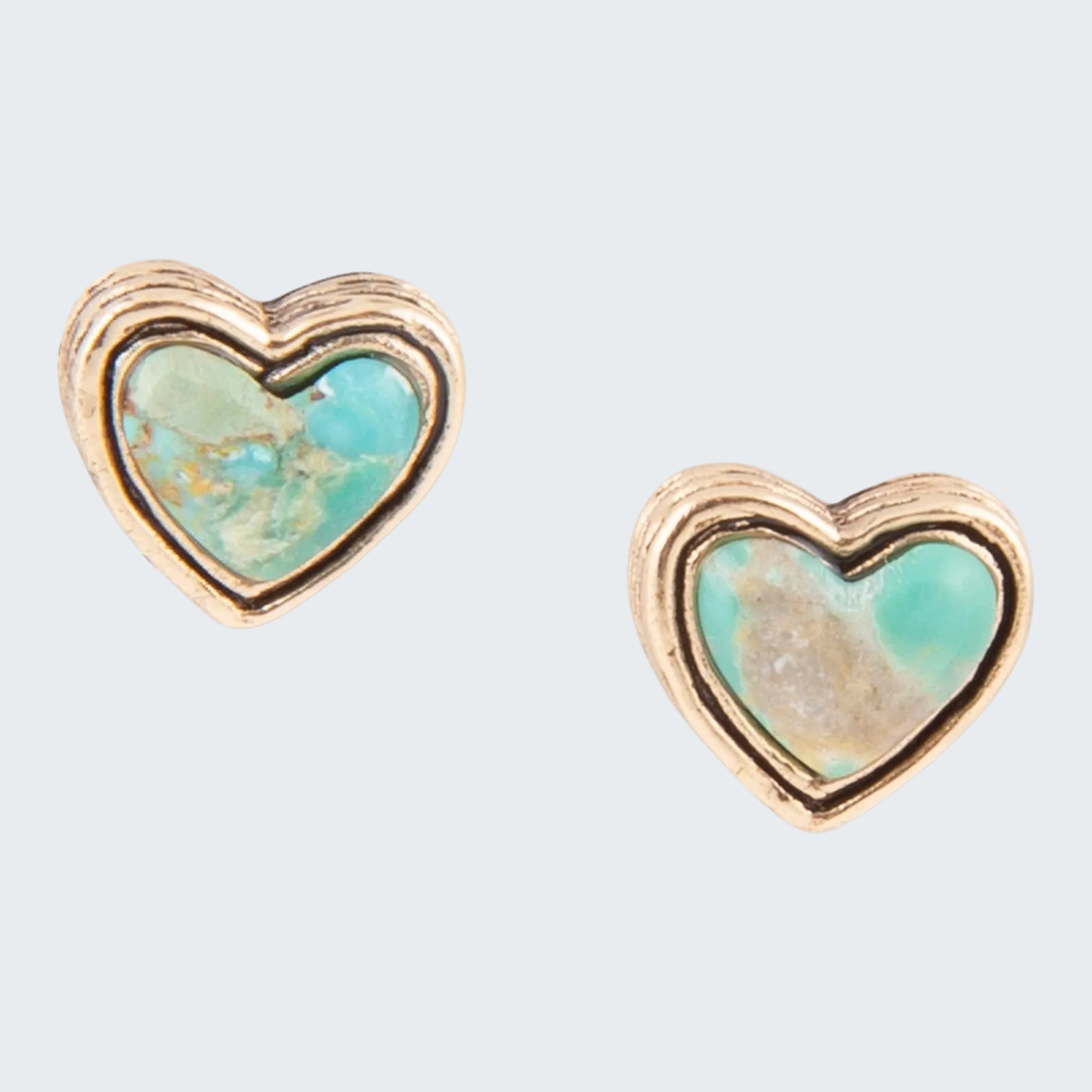 Heart-shaped earrings with turquoise center and gold border on a white background