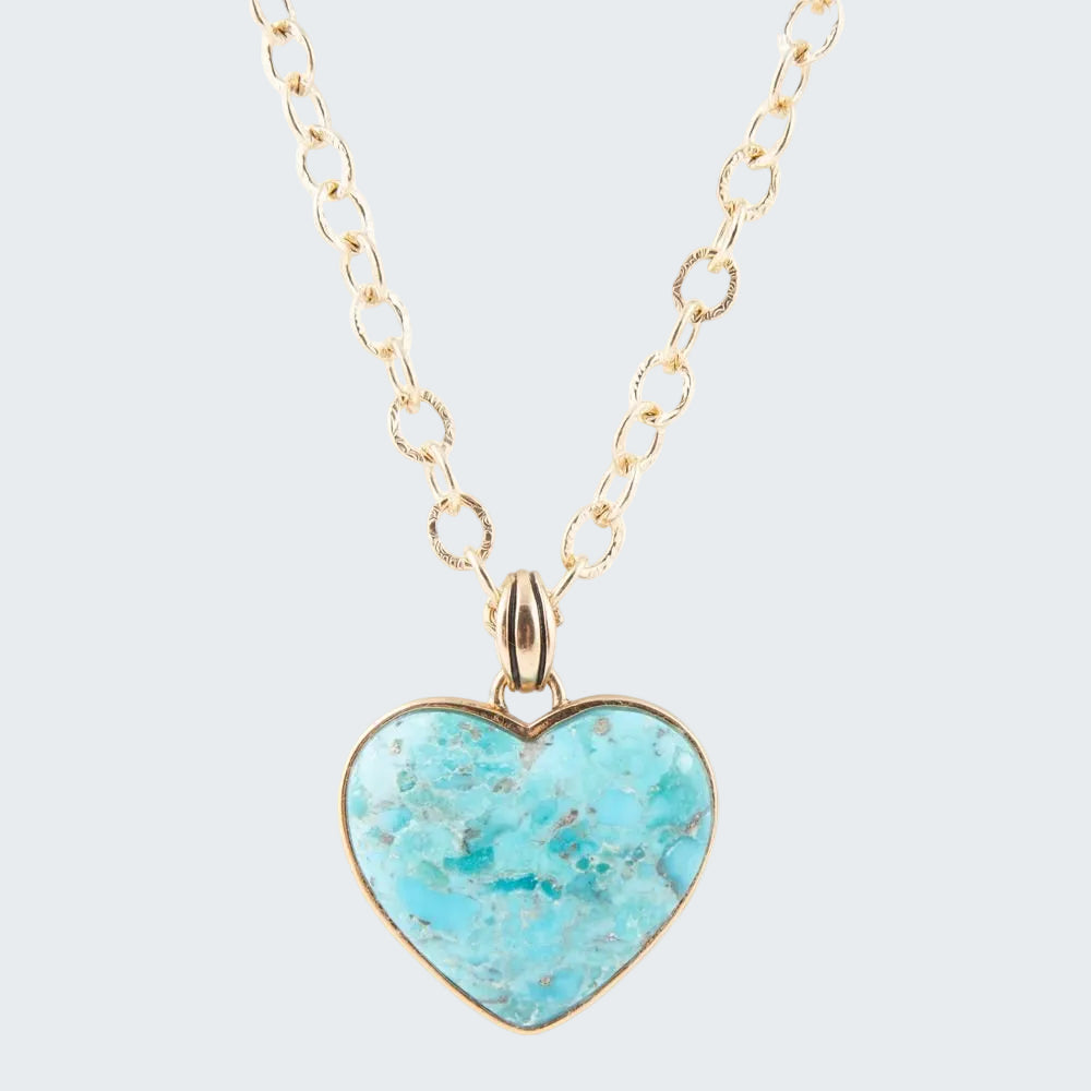 Turquoise heart-shaped pendant on a gold chain against a white background