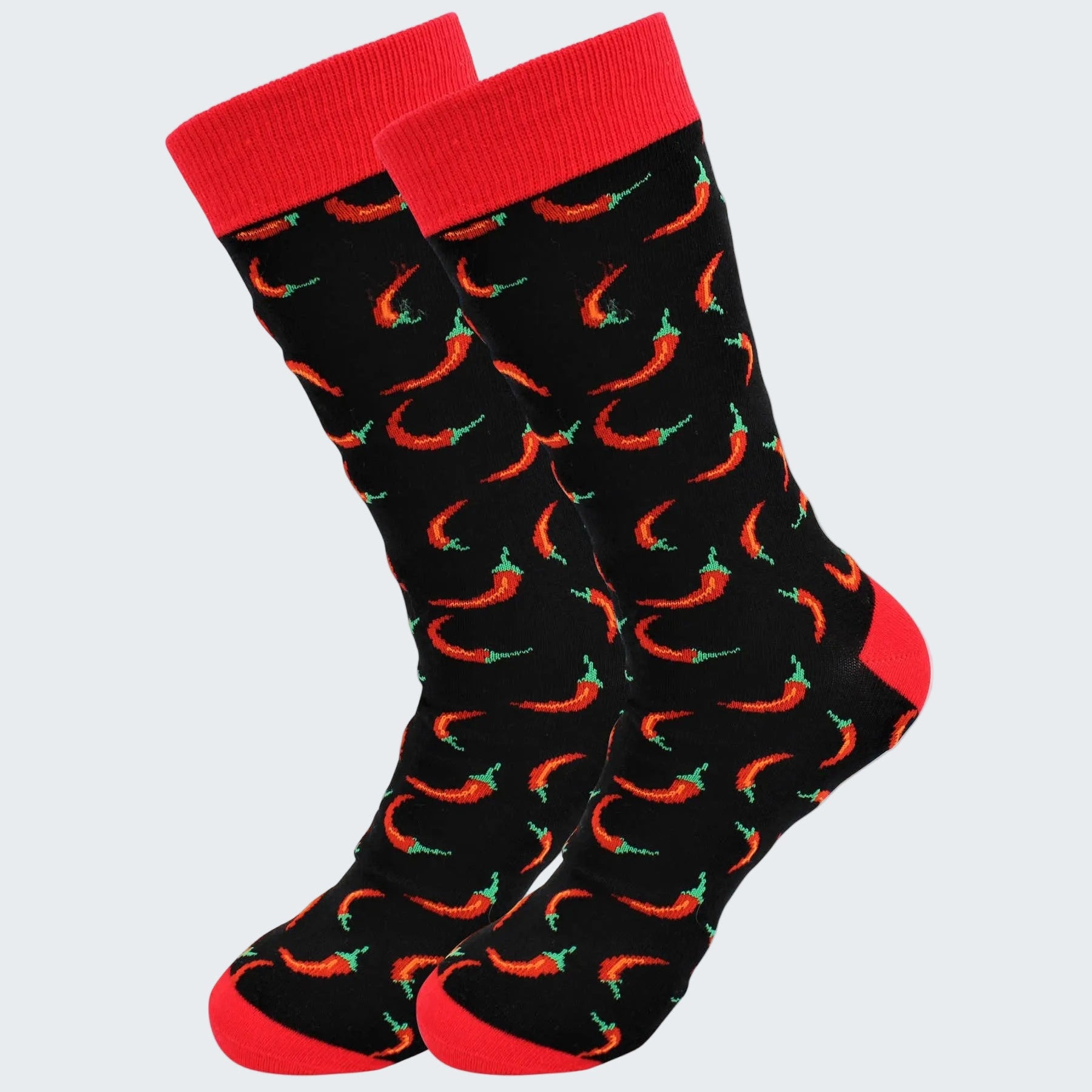 Black socks with red chili pepper pattern and red cuffs on a white background