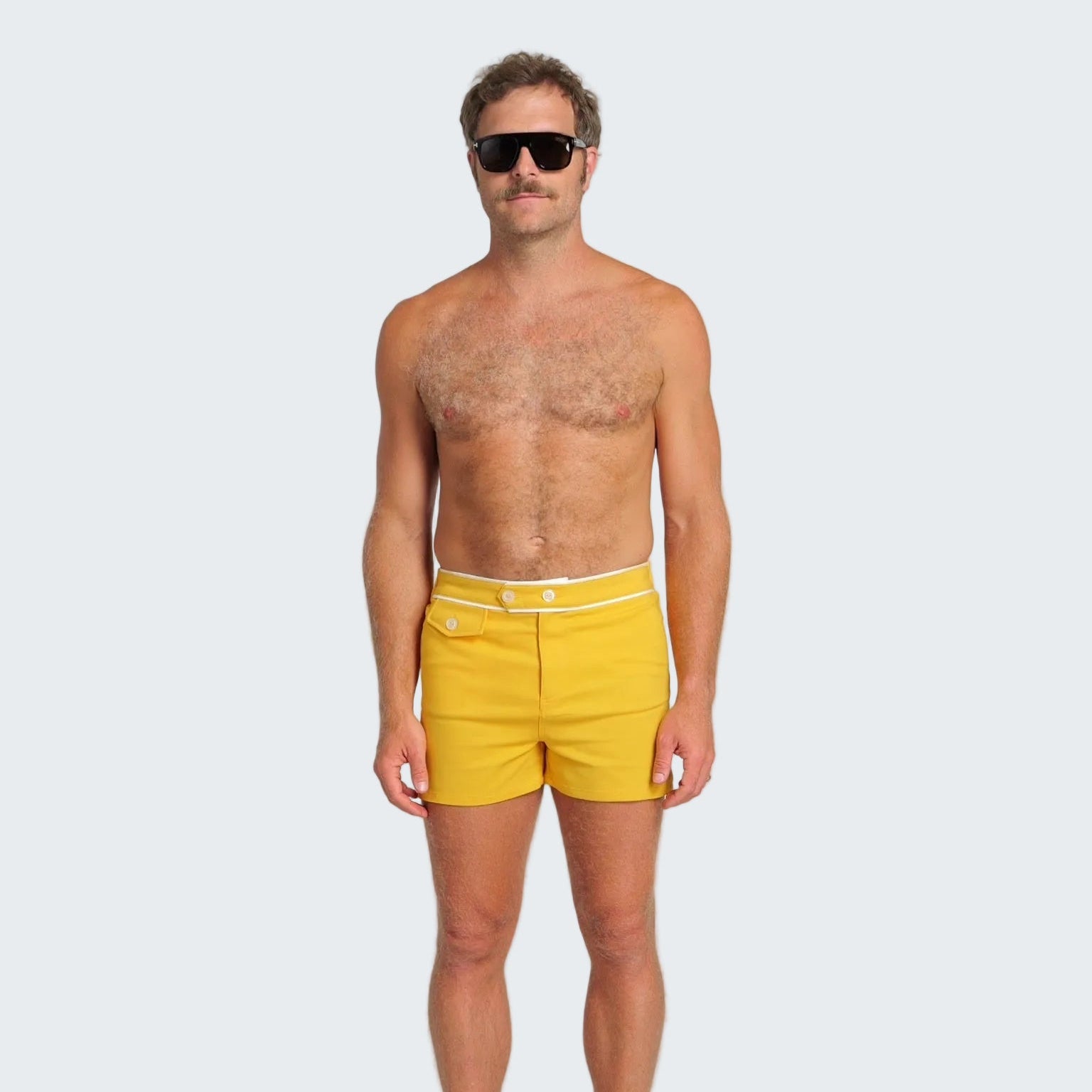 Man wearing yellow swim shorts on a white background