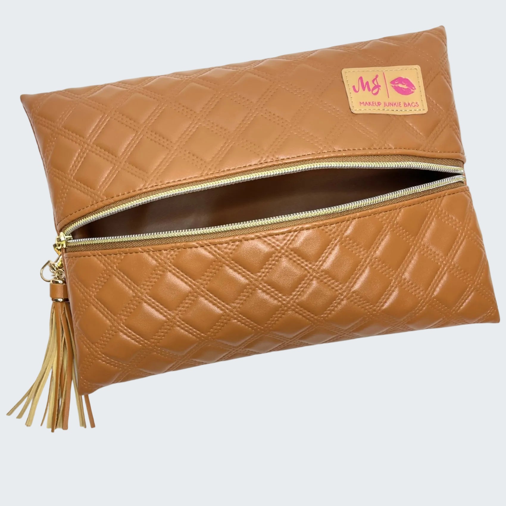 Quilted brown clutch bag with a tassel on a white background