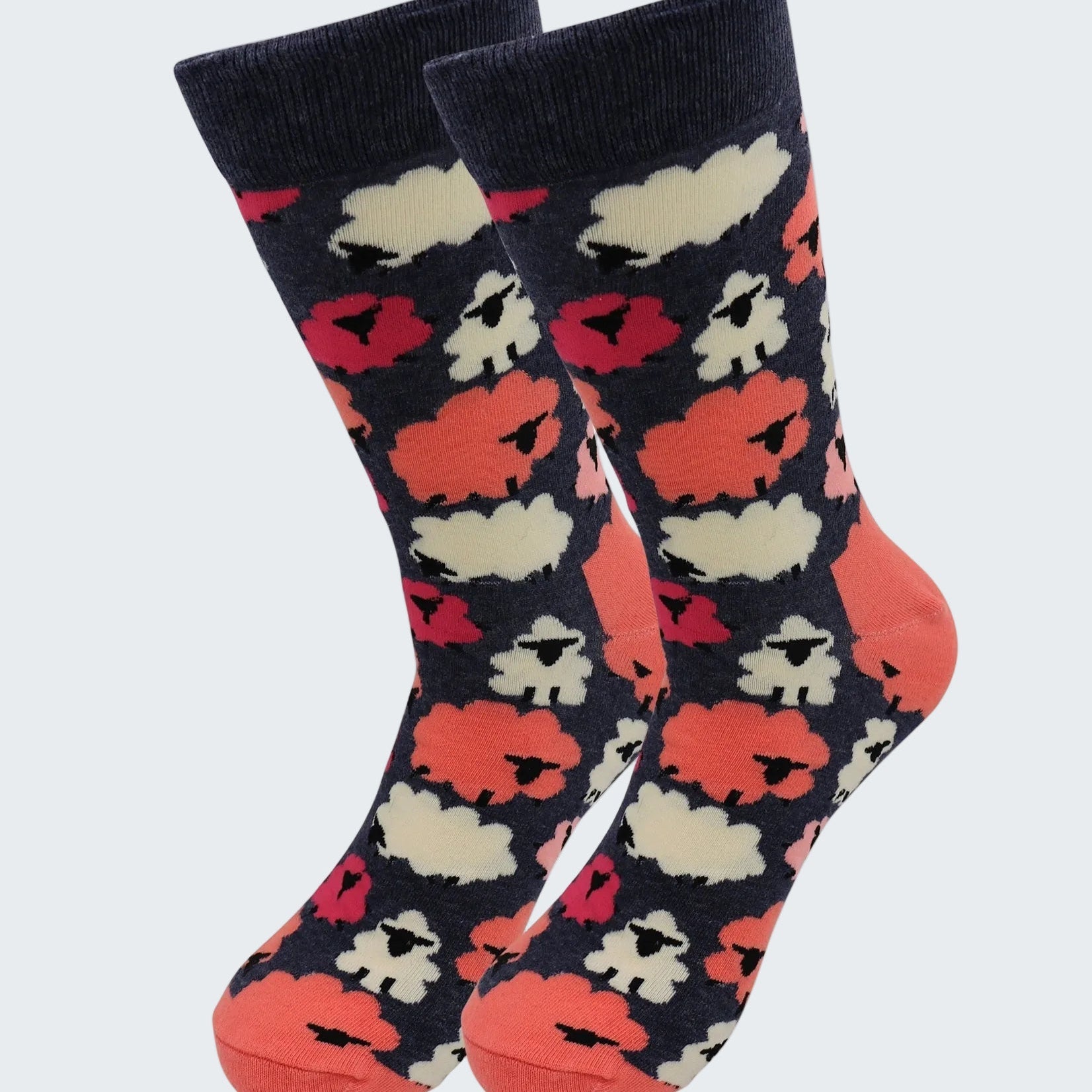 Pair of socks with a pattern of red, white, and black shapes on a dark background