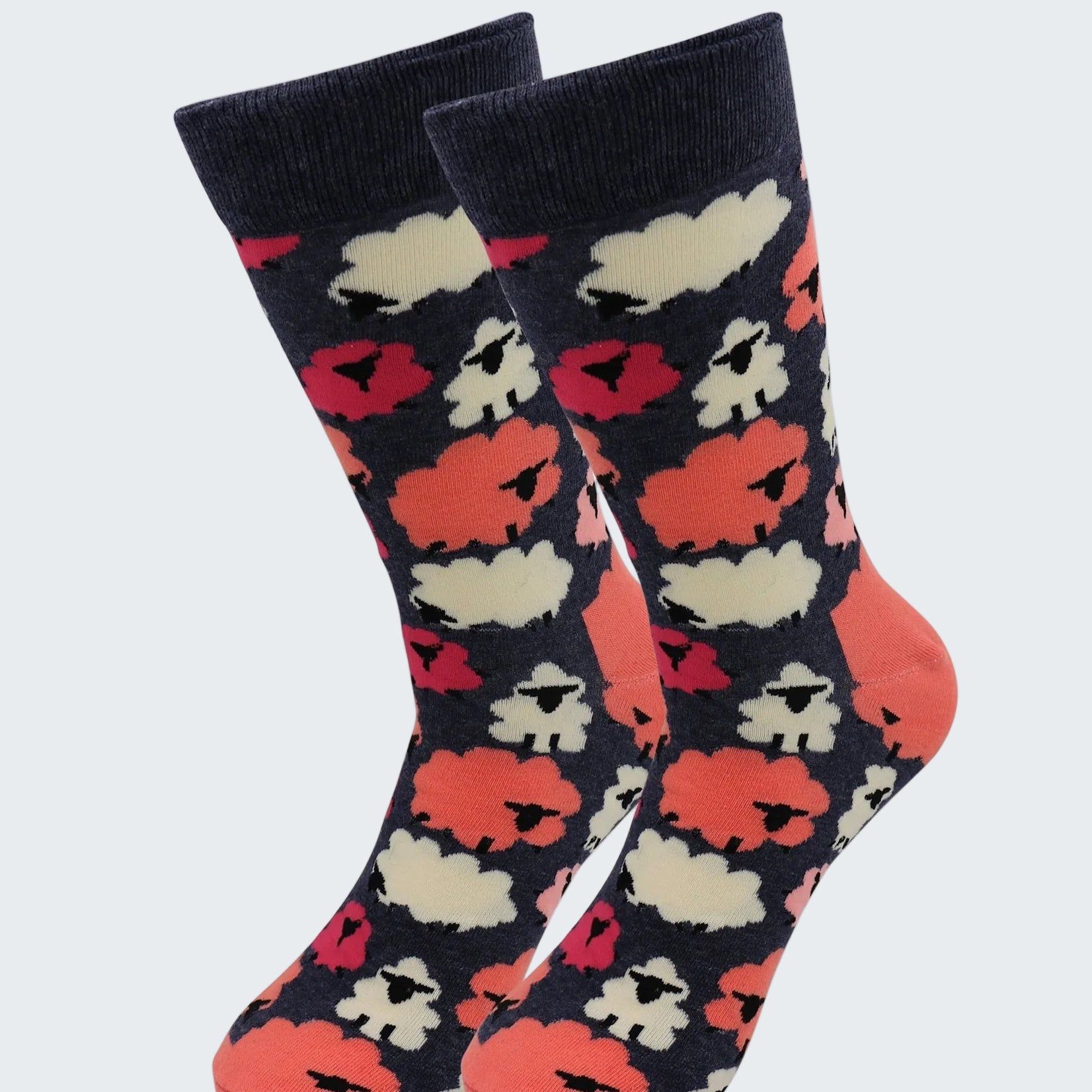 Pair of socks with a pattern of red, white, and black shapes on a dark background