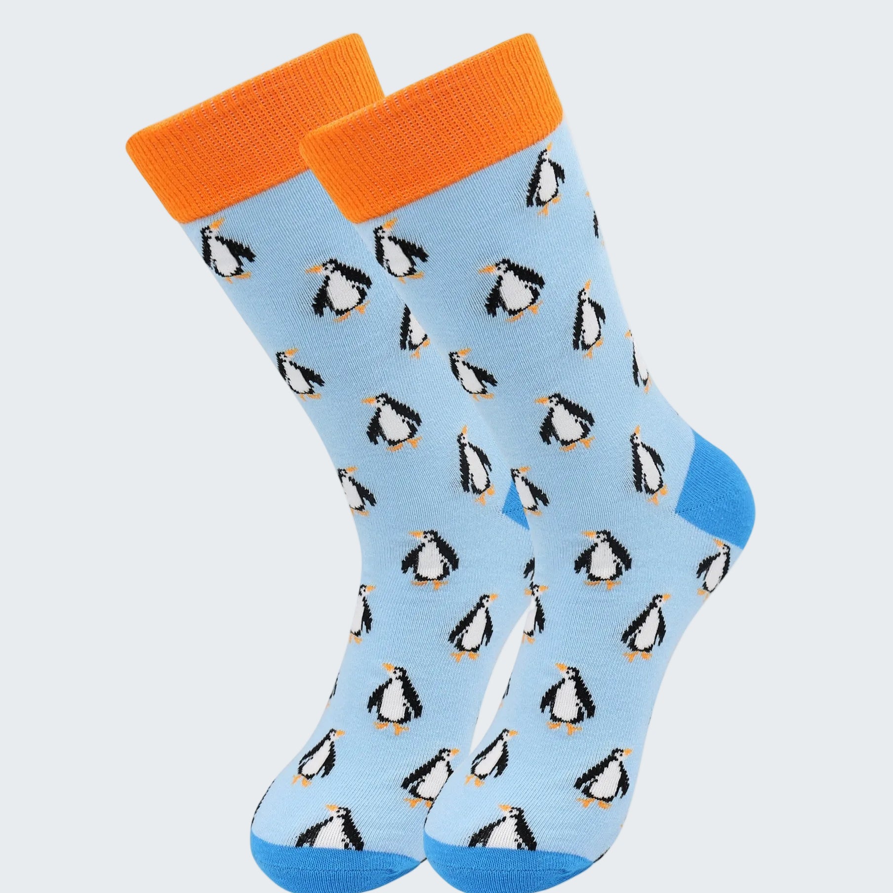Light blue socks with penguin pattern and orange cuffs on a white background
