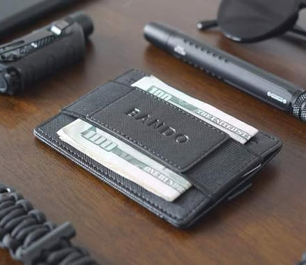 Black wallet with cards on a wooden surface with tools and accessories.