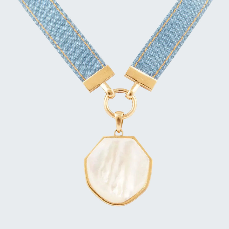 Necklace with a shell pendant and blue ribbon on a white background