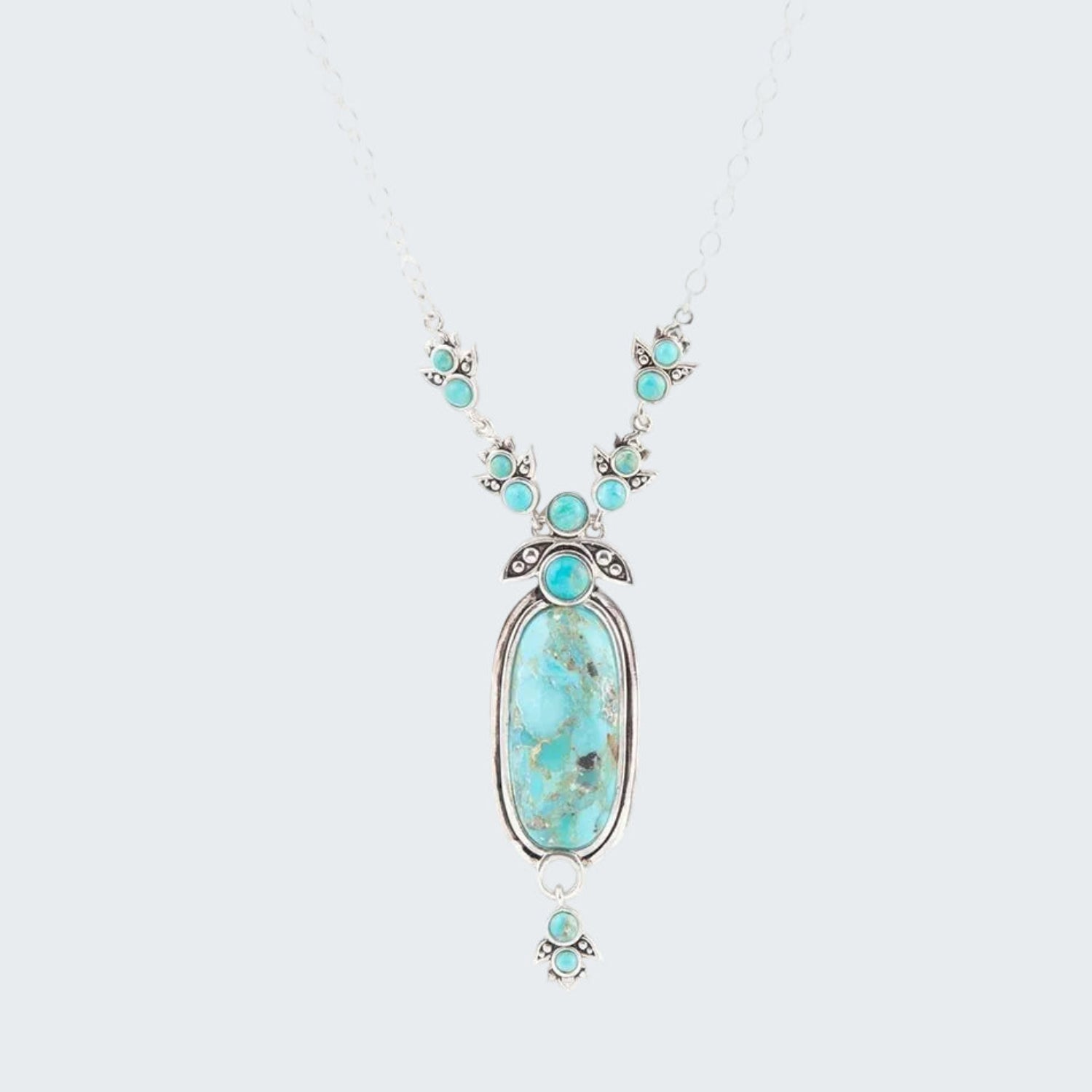 Turquoise necklace with silver chain on a white background