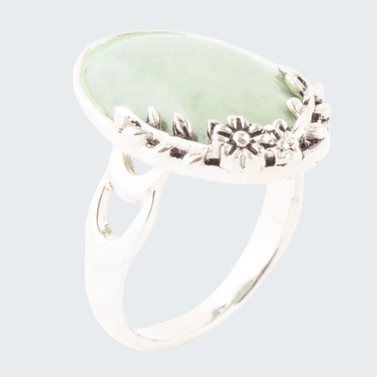 Silver ring with a large green stone on a white background