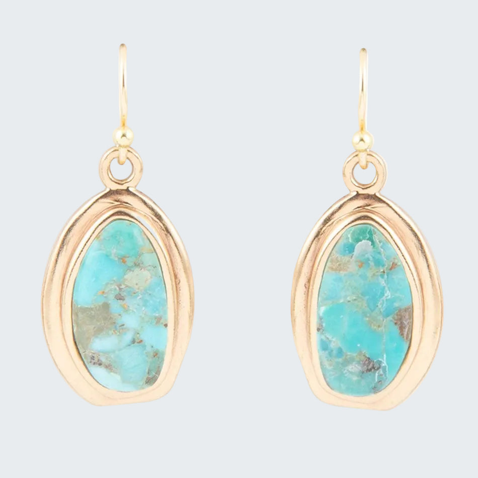 Turquoise stone earrings with gold frames on a white background