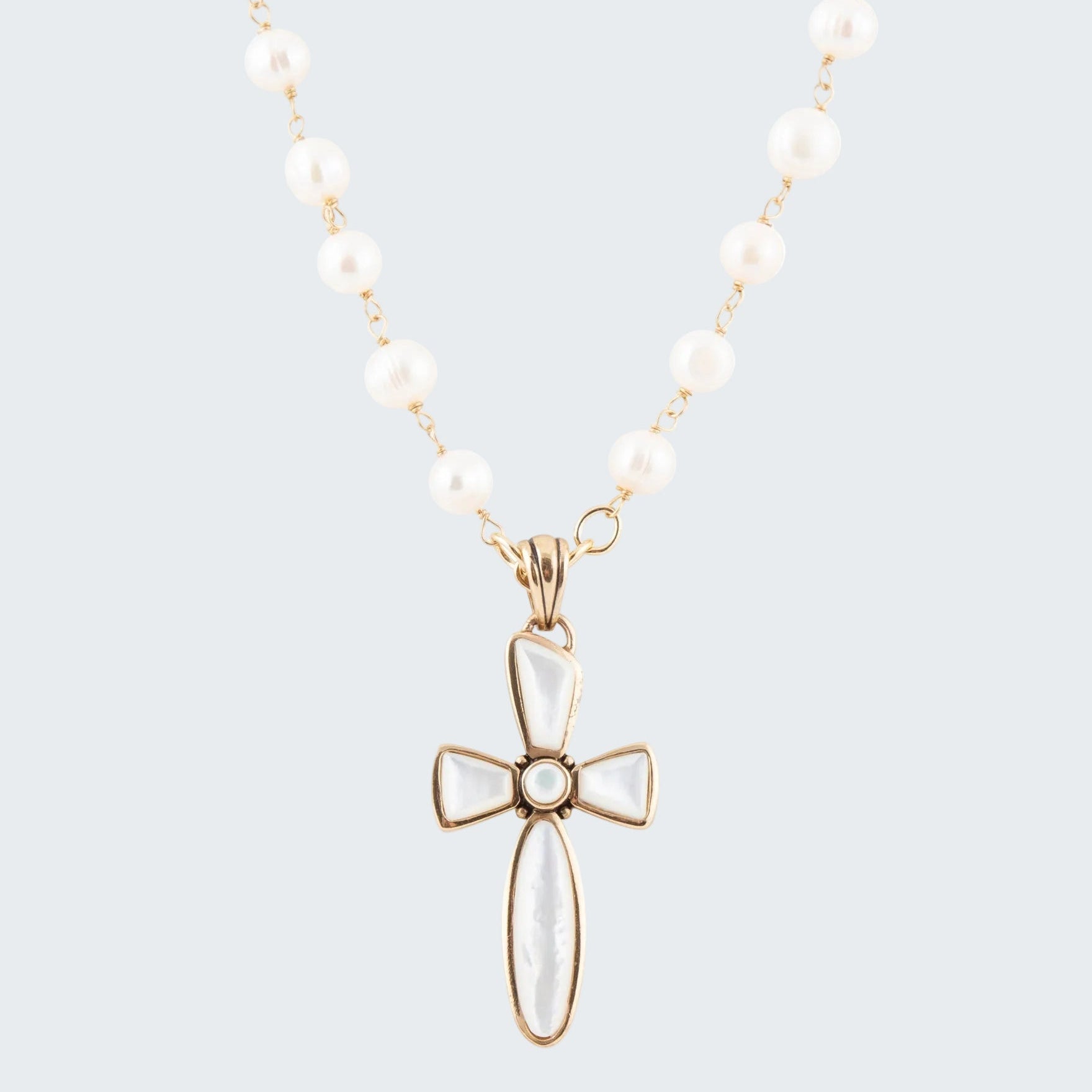 Necklace with a white cross pendant on a white background