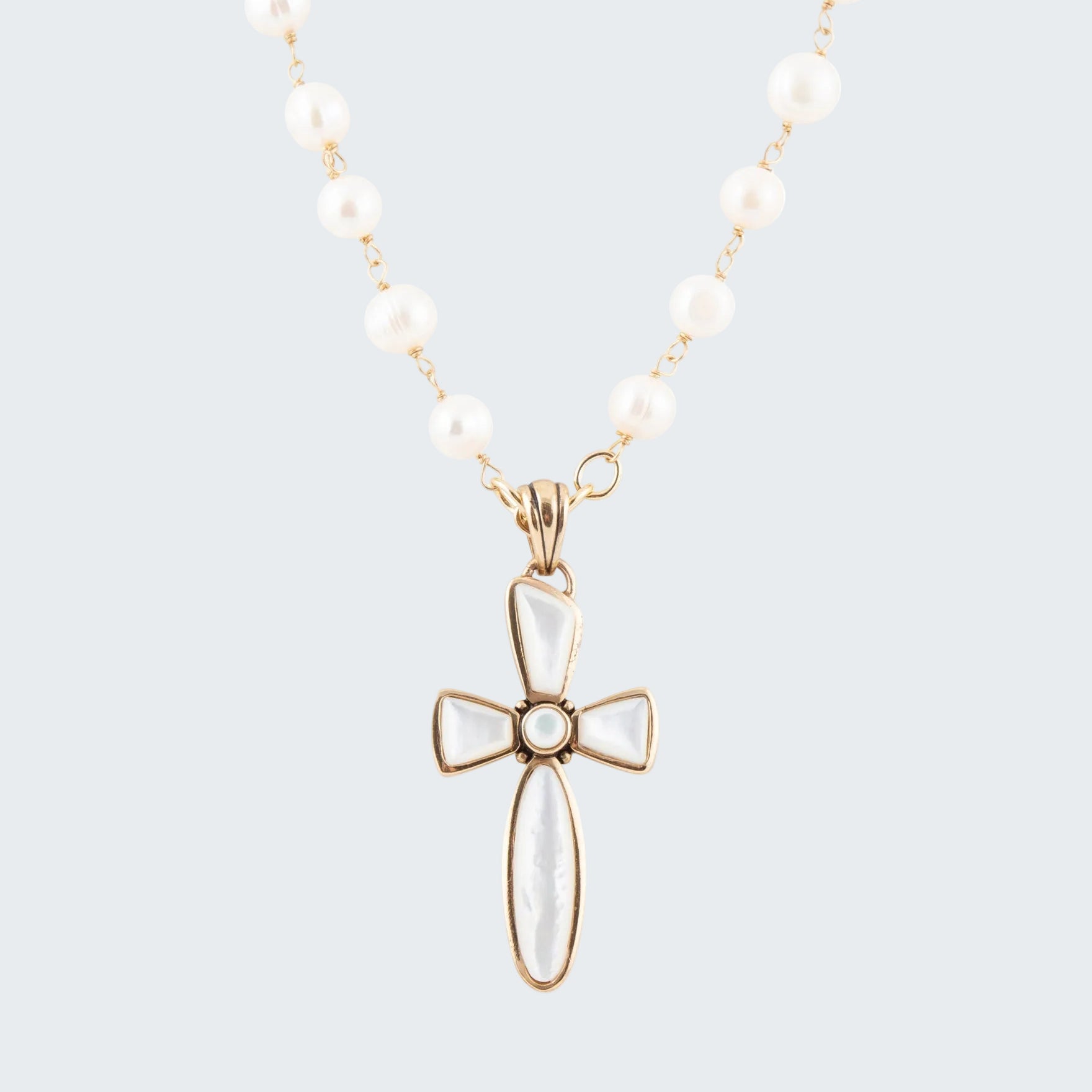 Necklace with a white cross pendant on a white background