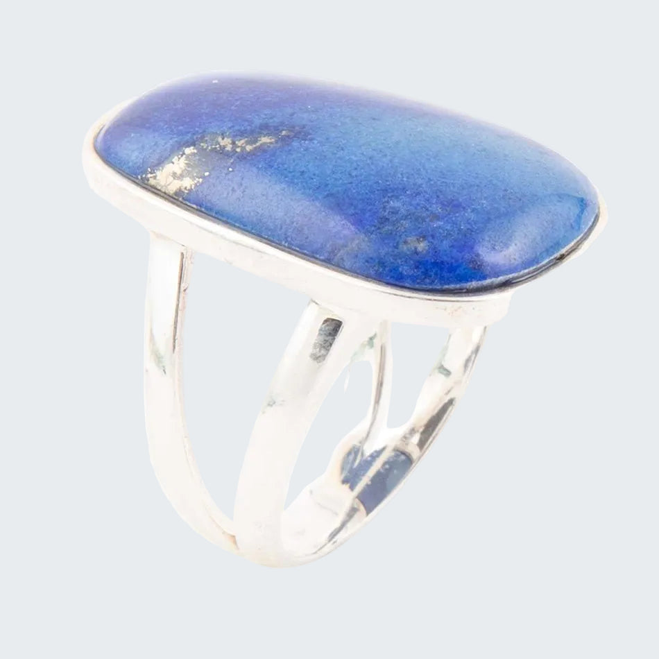 Silver ring with a large blue stone on a white background