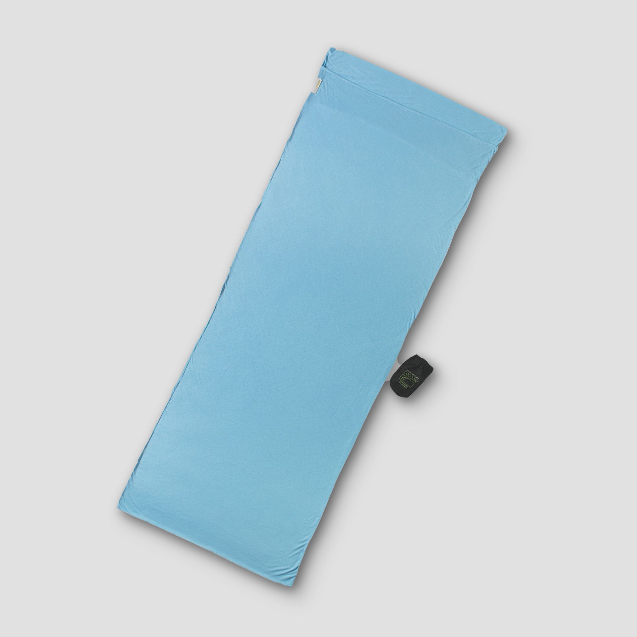 Light blue folded mat with a black button on a light gray background