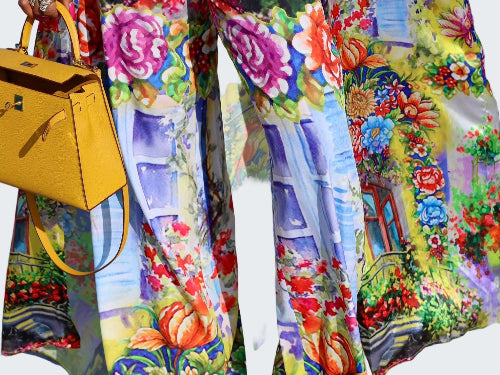 Colorful floral and architectural patterned pants with a yellow handbag.