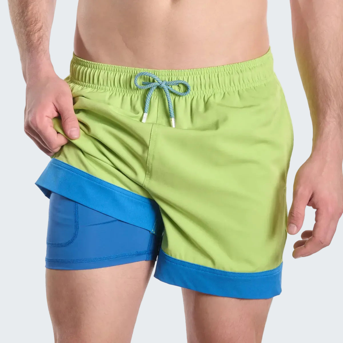 Green and blue swim shorts on a white background