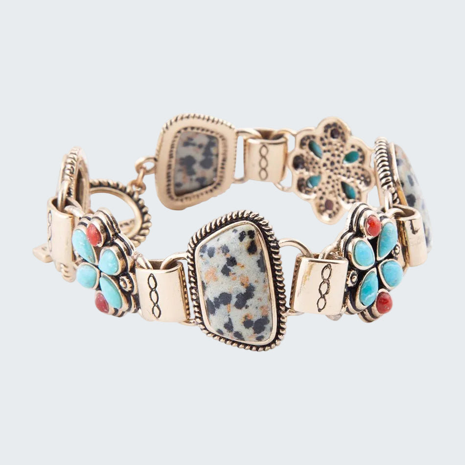 Multicolored bracelet with floral and square designs on a white background