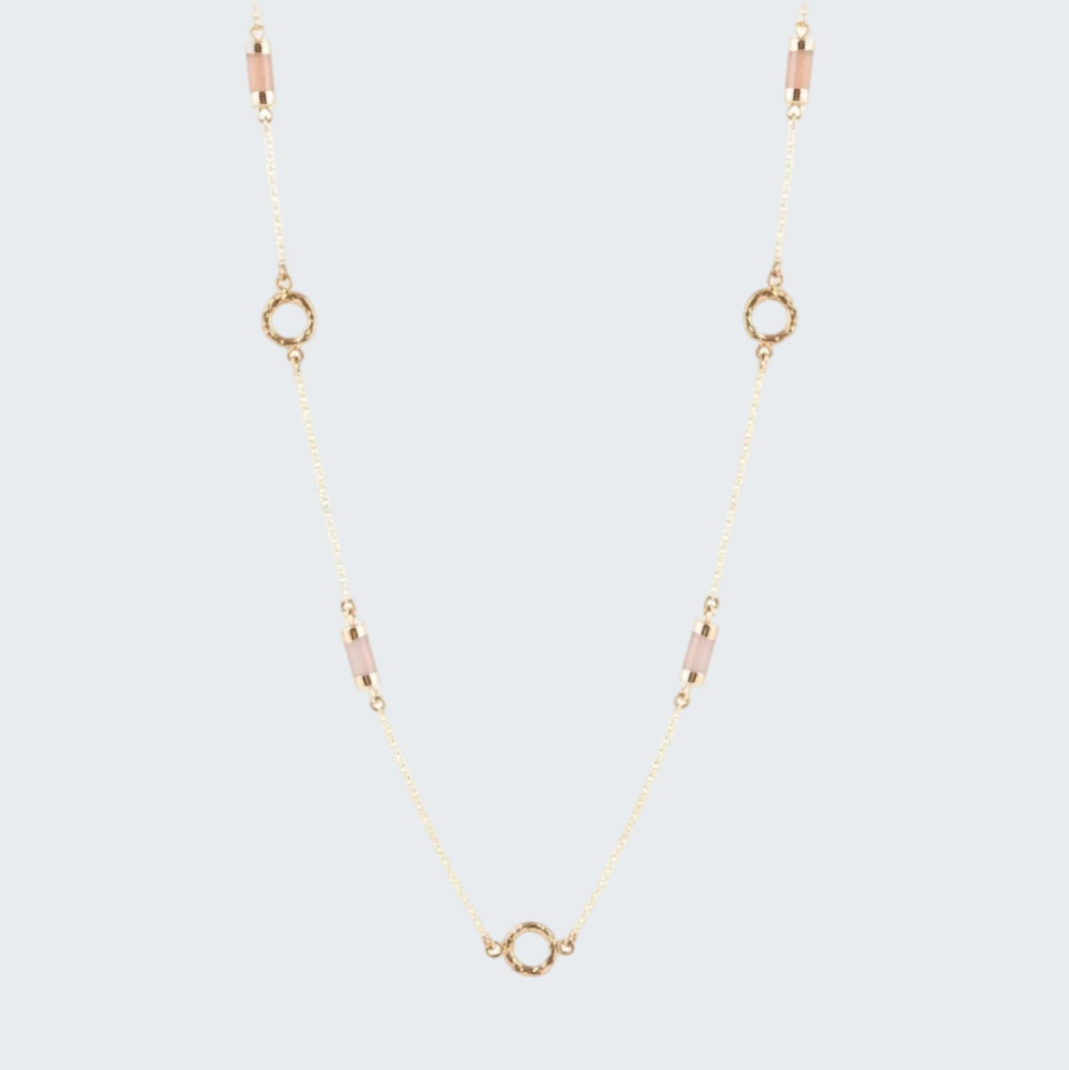 Gold necklace with small circular pendants on a white background