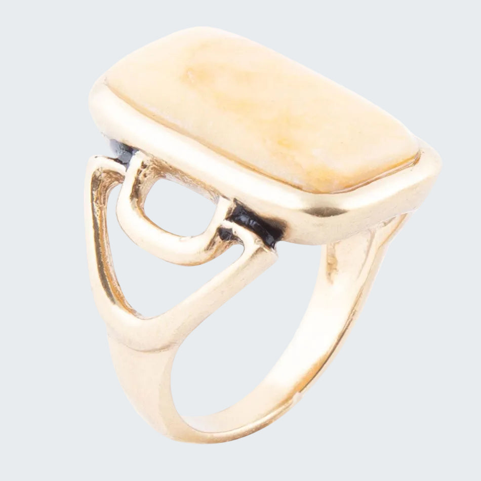 Gold ring with a unique design on a white background