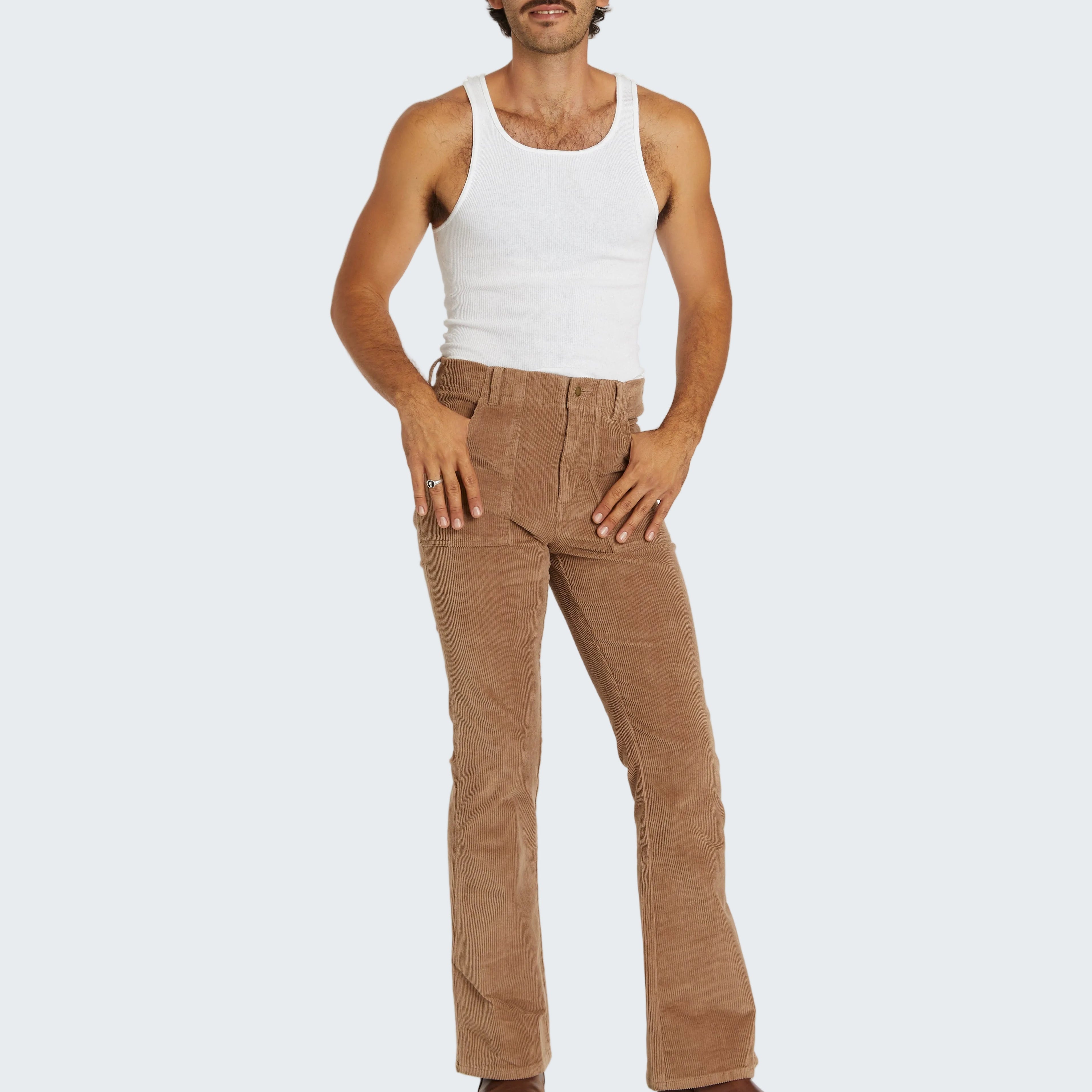 Man wearing a white tank top and brown pants on a white background