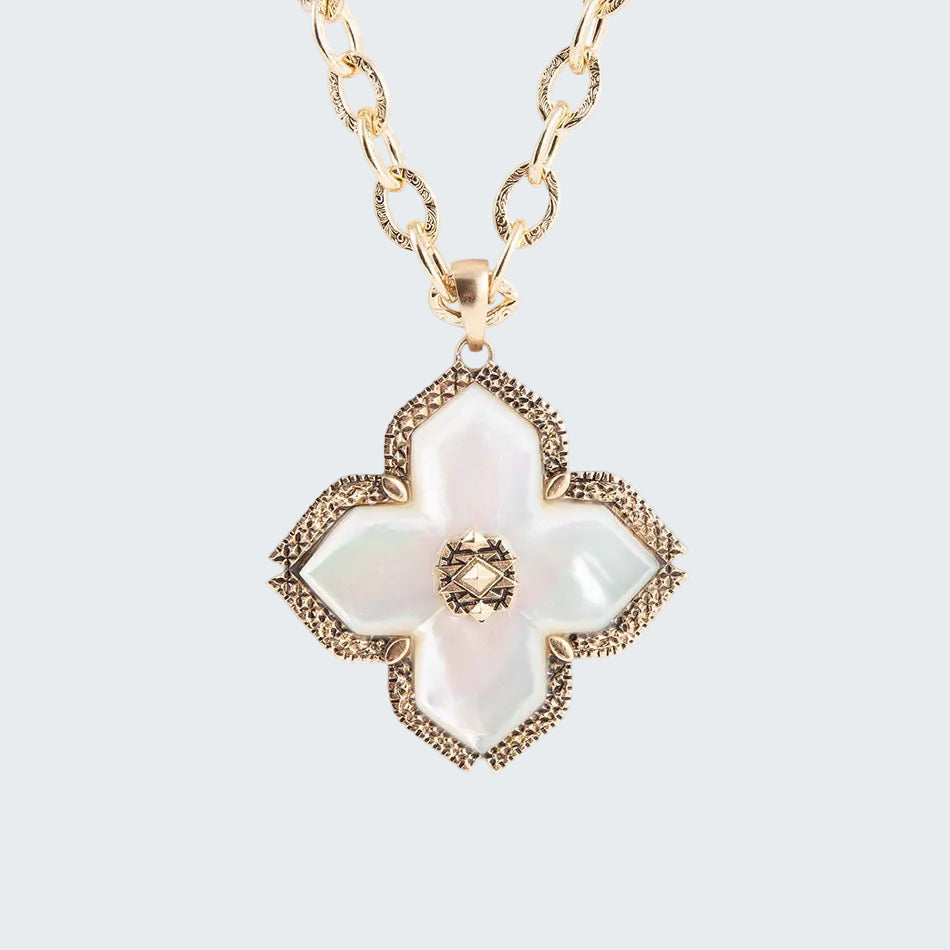 Gold necklace with a floral pendant on a white background
