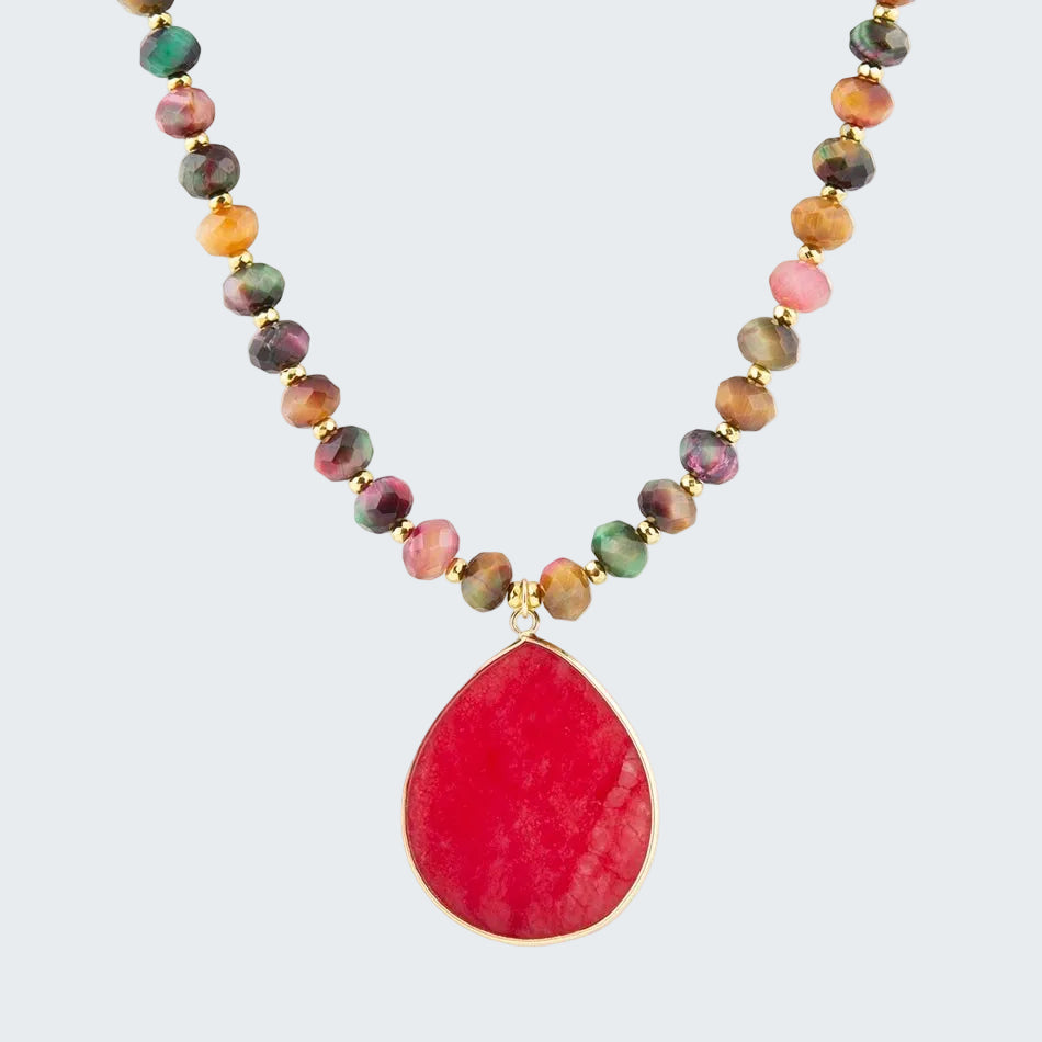 Necklace with multicolored beads and a large red teardrop pendant on a white background