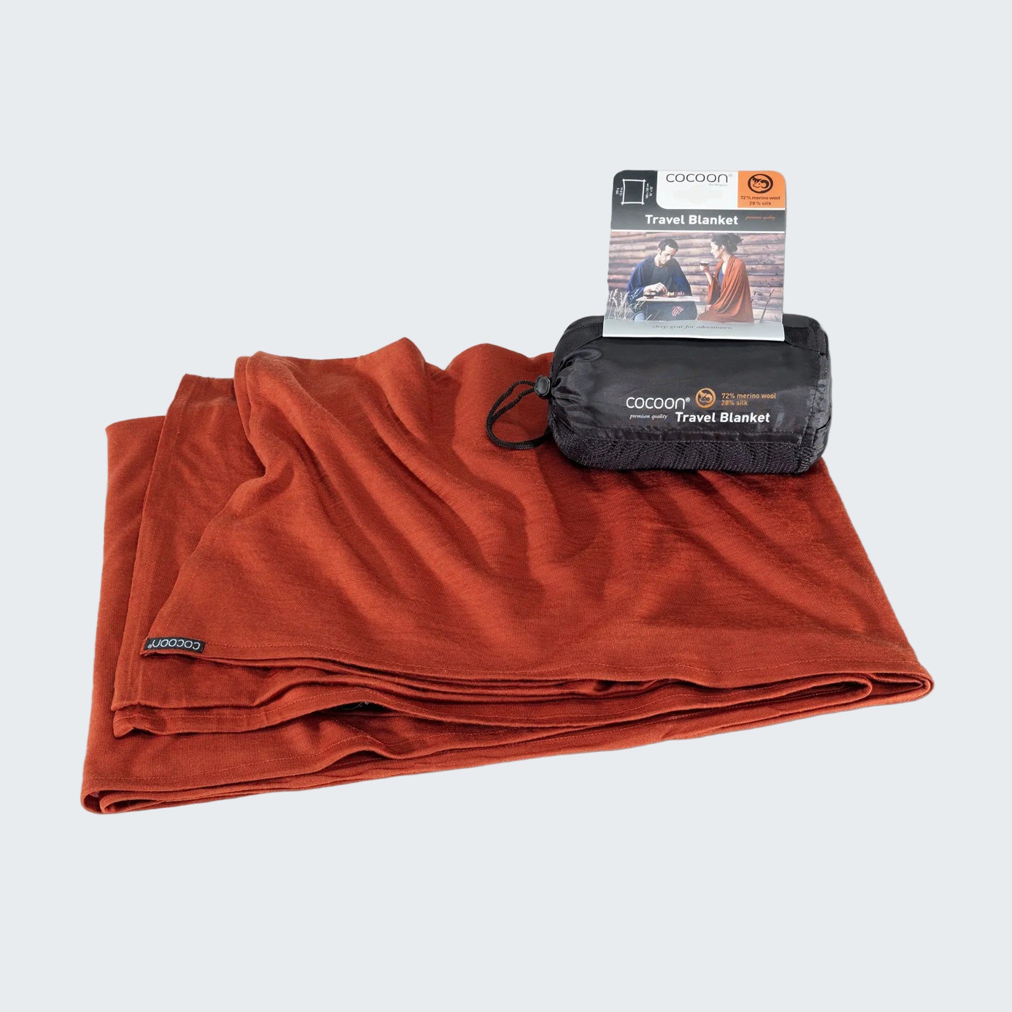 Orange travel blanket with packaging on a gray background