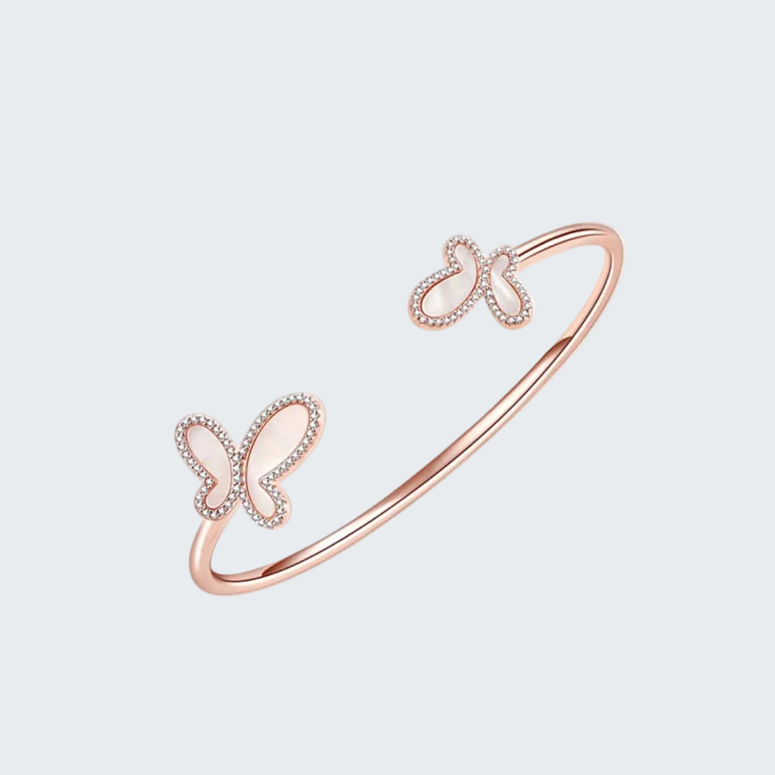 Rose gold bracelet with butterfly designs on a white background