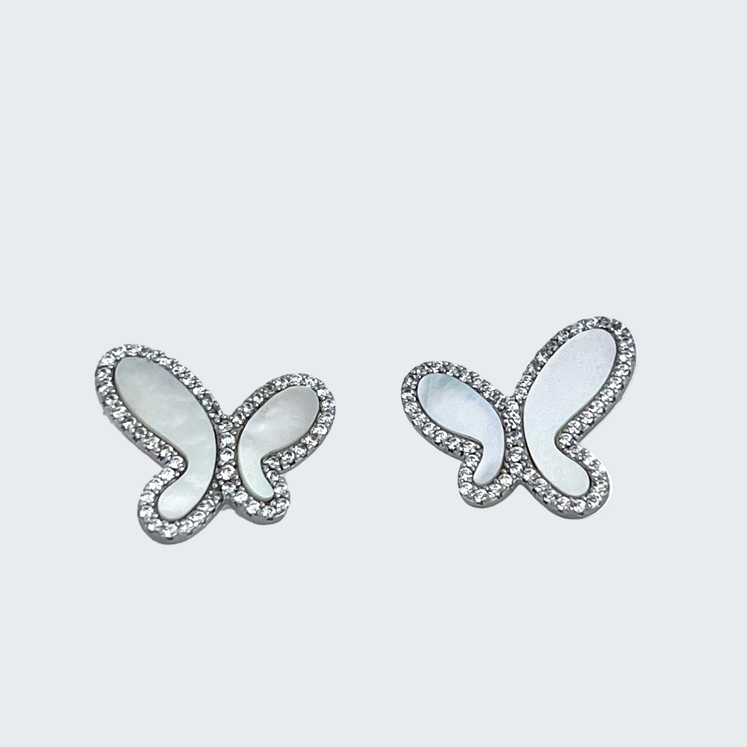 Butterfly-shaped earrings with gemstones on a white background