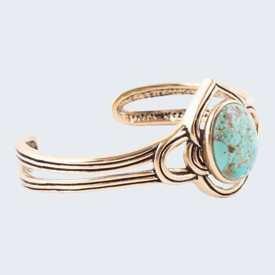 Gold bracelet with a turquoise stone on a white background