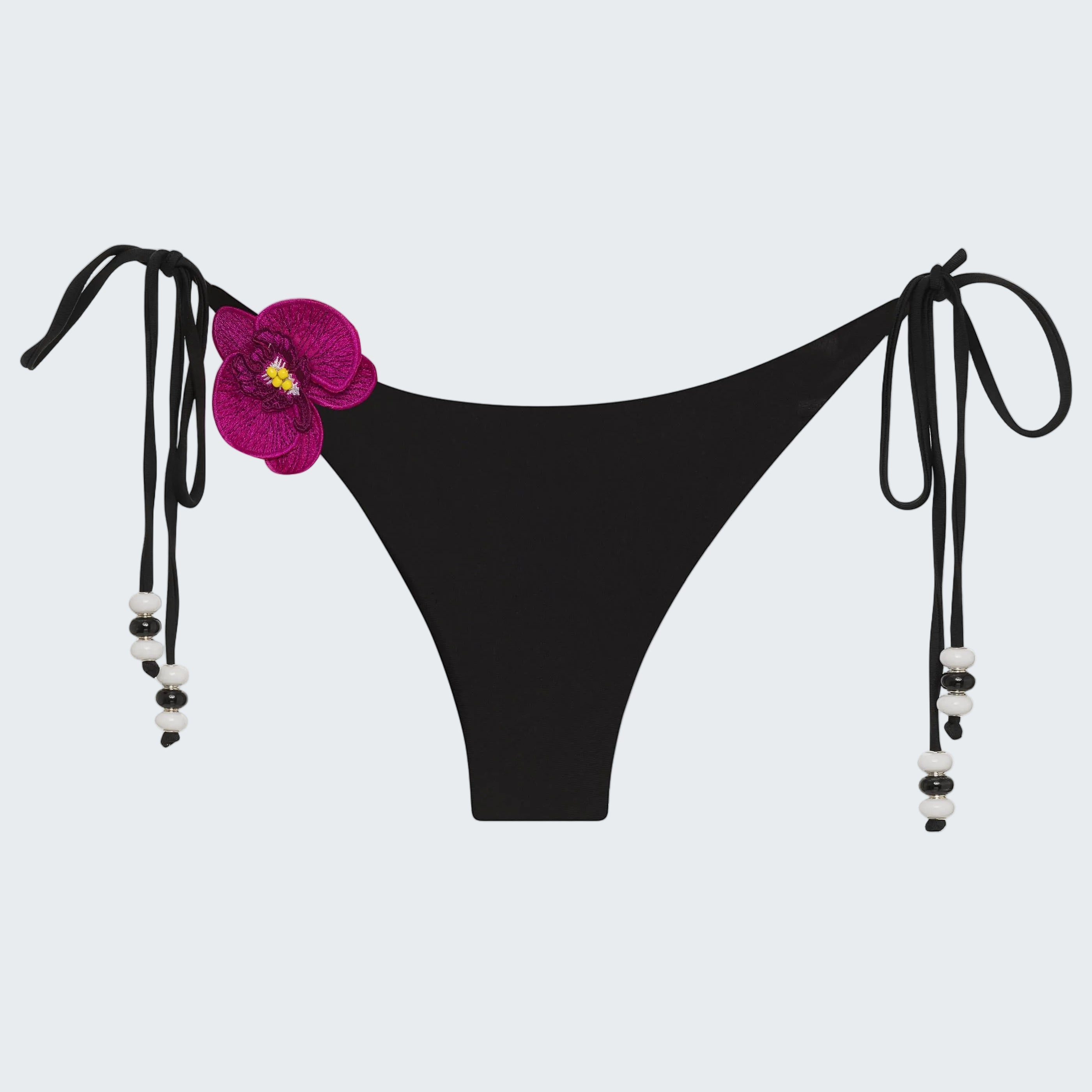 Black bikini bottom with floral design and straps on a white background