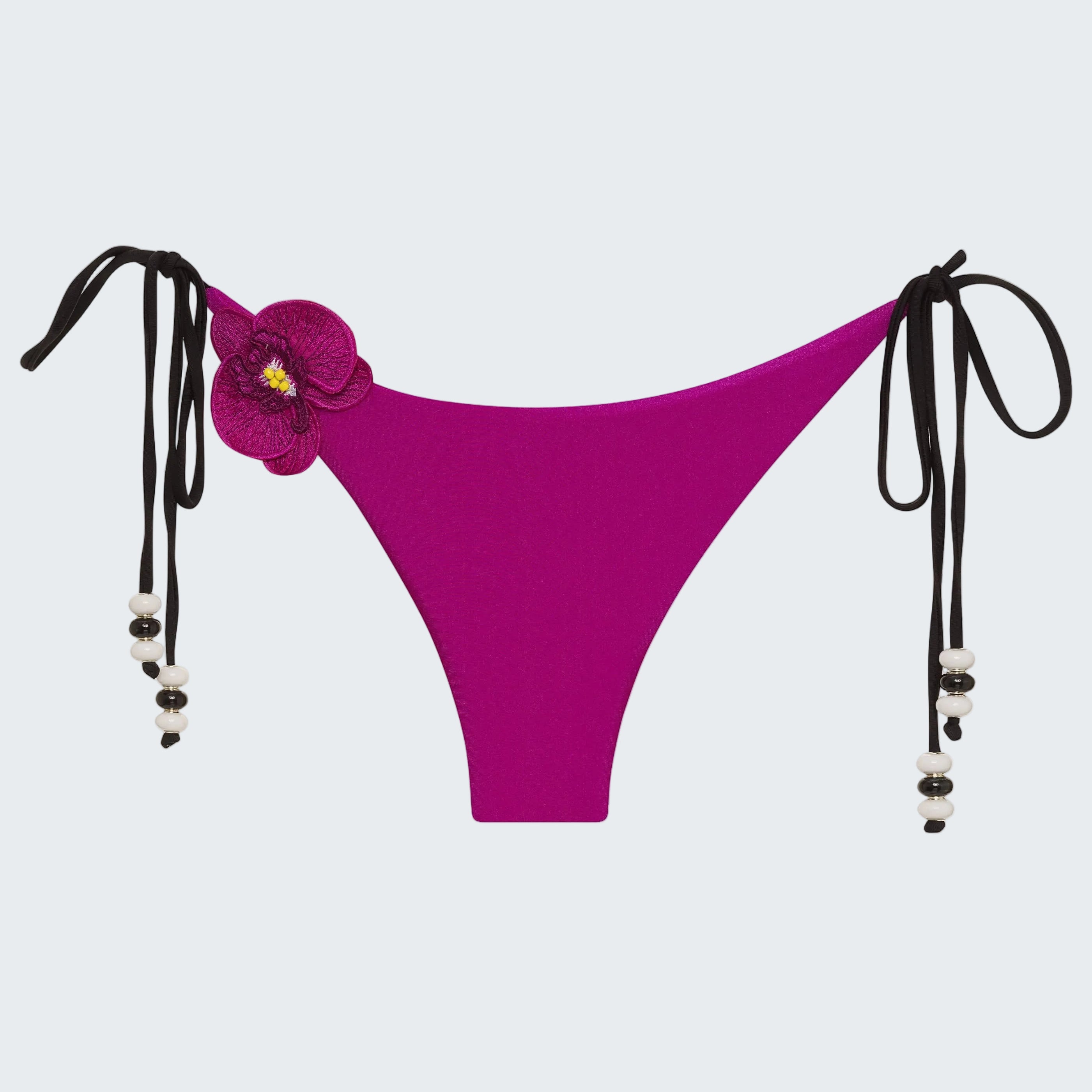 Purple bikini bottom with floral design and black straps on a white background