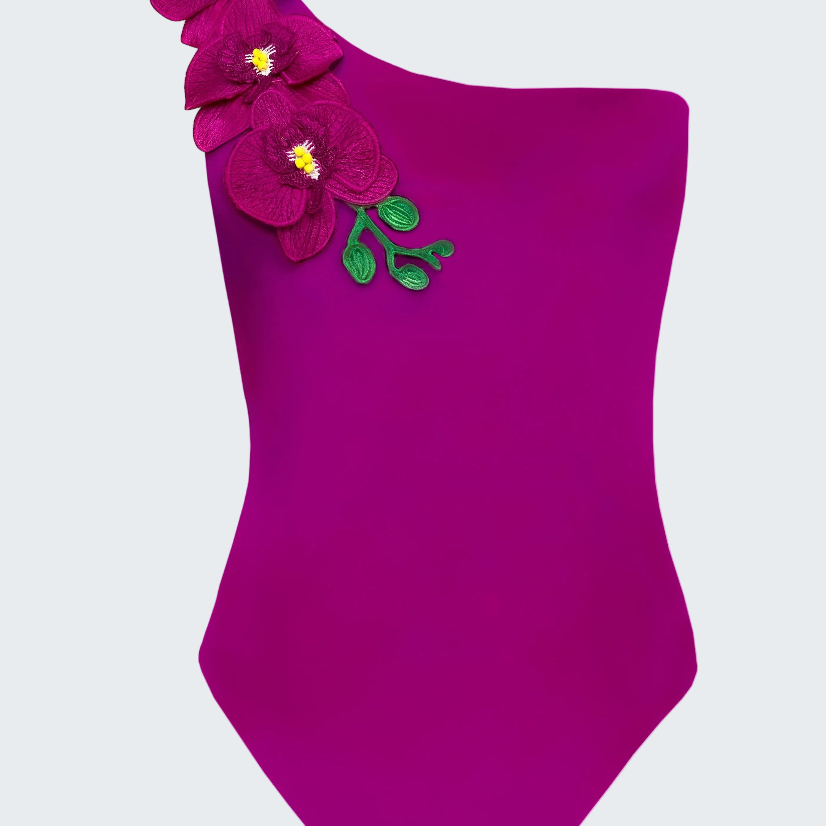 Purple one-shoulder swimsuit with floral decorations on a white background