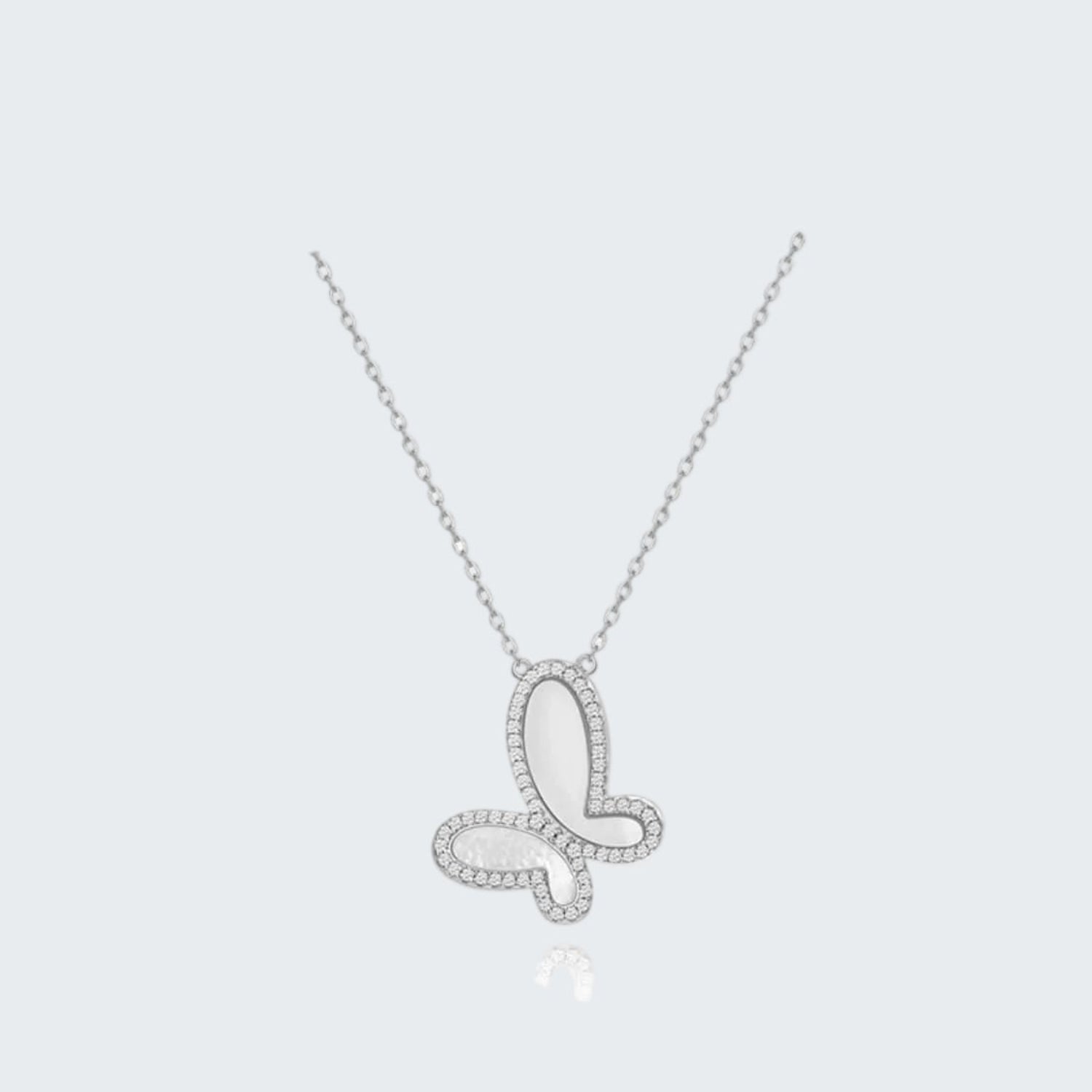 Butterfly-shaped silver necklace on a white background