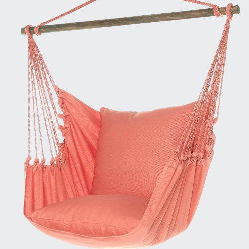 Coral hammock chair with pillow on a white background