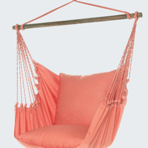 Coral hammock chair with pillow on a white background