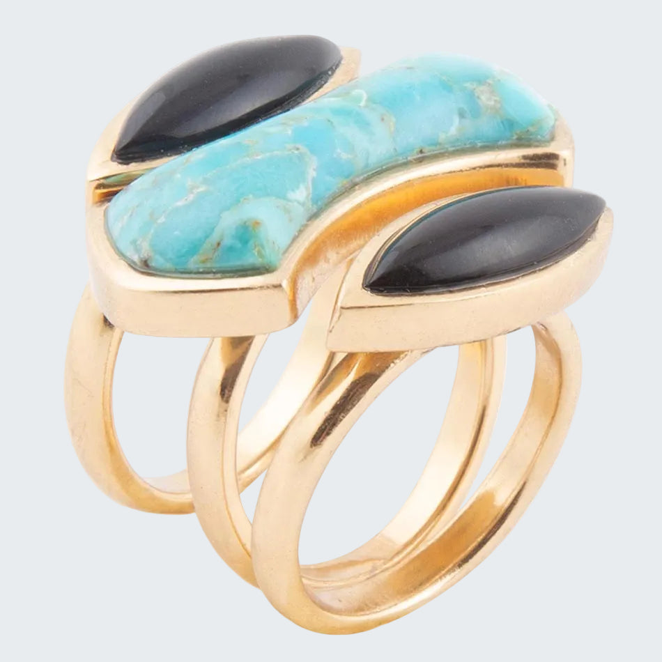 Gold ring with turquoise and black stone inlays on a white background