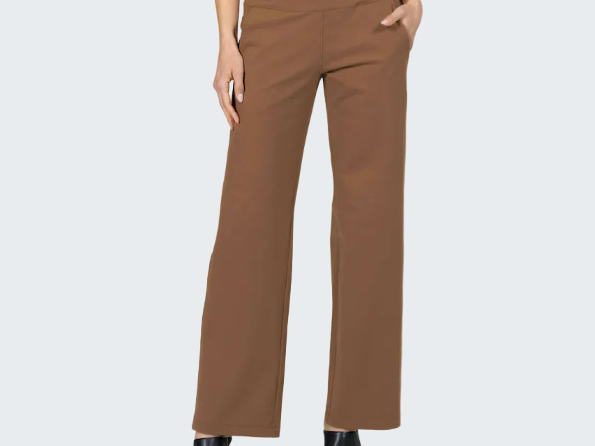 Brown pants worn by a person on a gray background