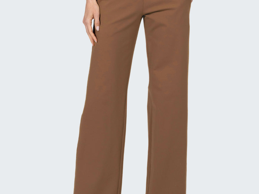 Brown pants worn by a person on a gray background