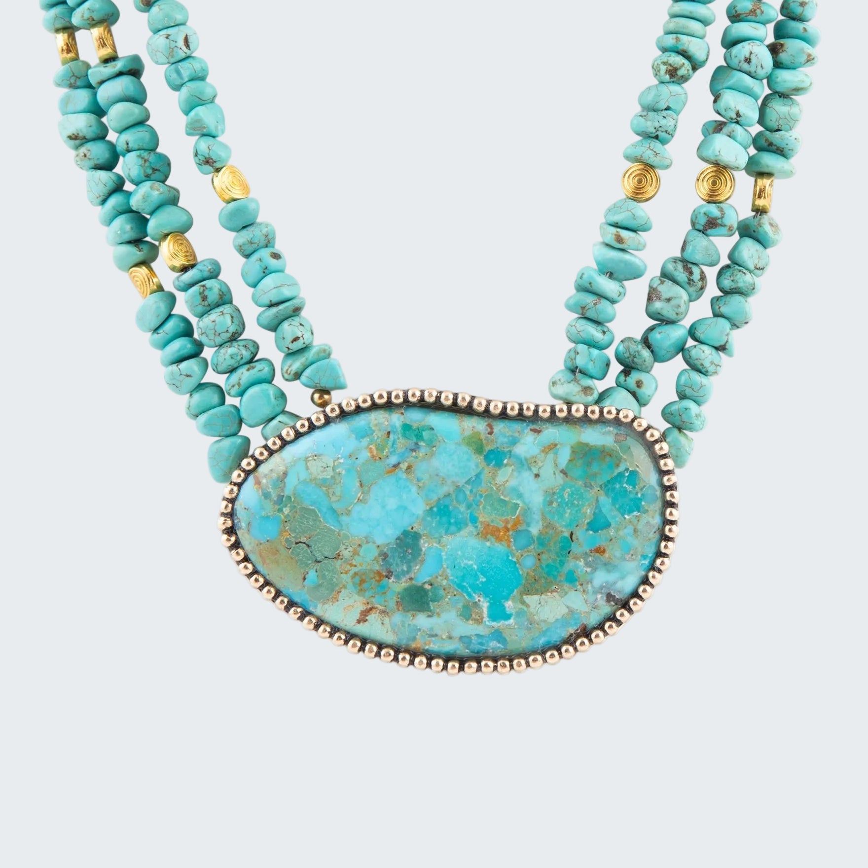 Turquoise beaded necklace with a large turquoise stone pendant on a white background