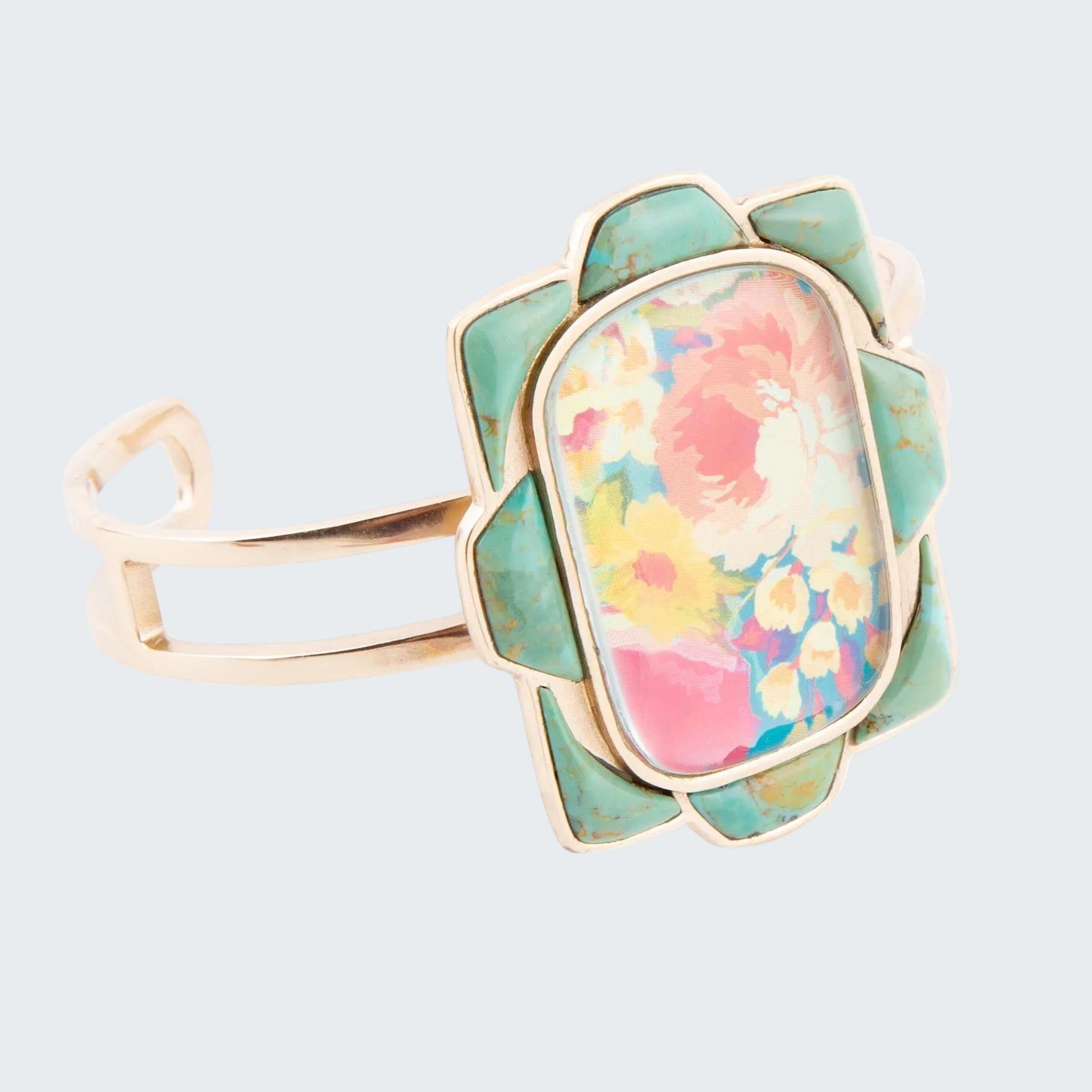 Ring with floral design and gold accents on a white background