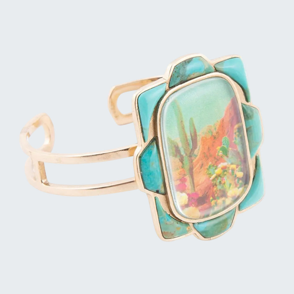 Turquoise stone ring with gold band on a white background