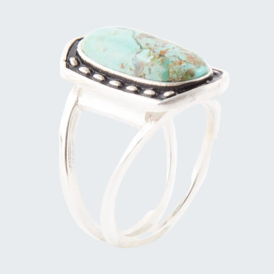 Silver ring with a turquoise stone on a white background