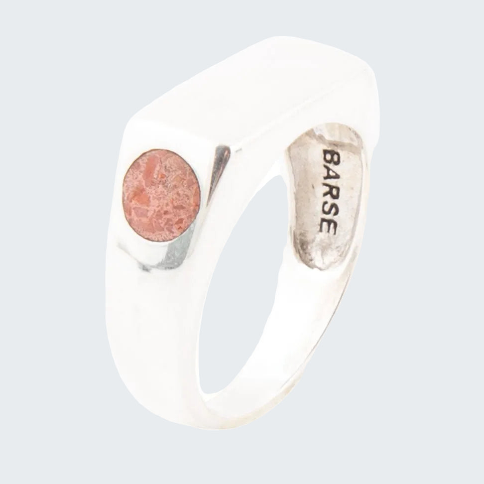 Silver ring with a pink stone and 'Barse' engraving on a white background